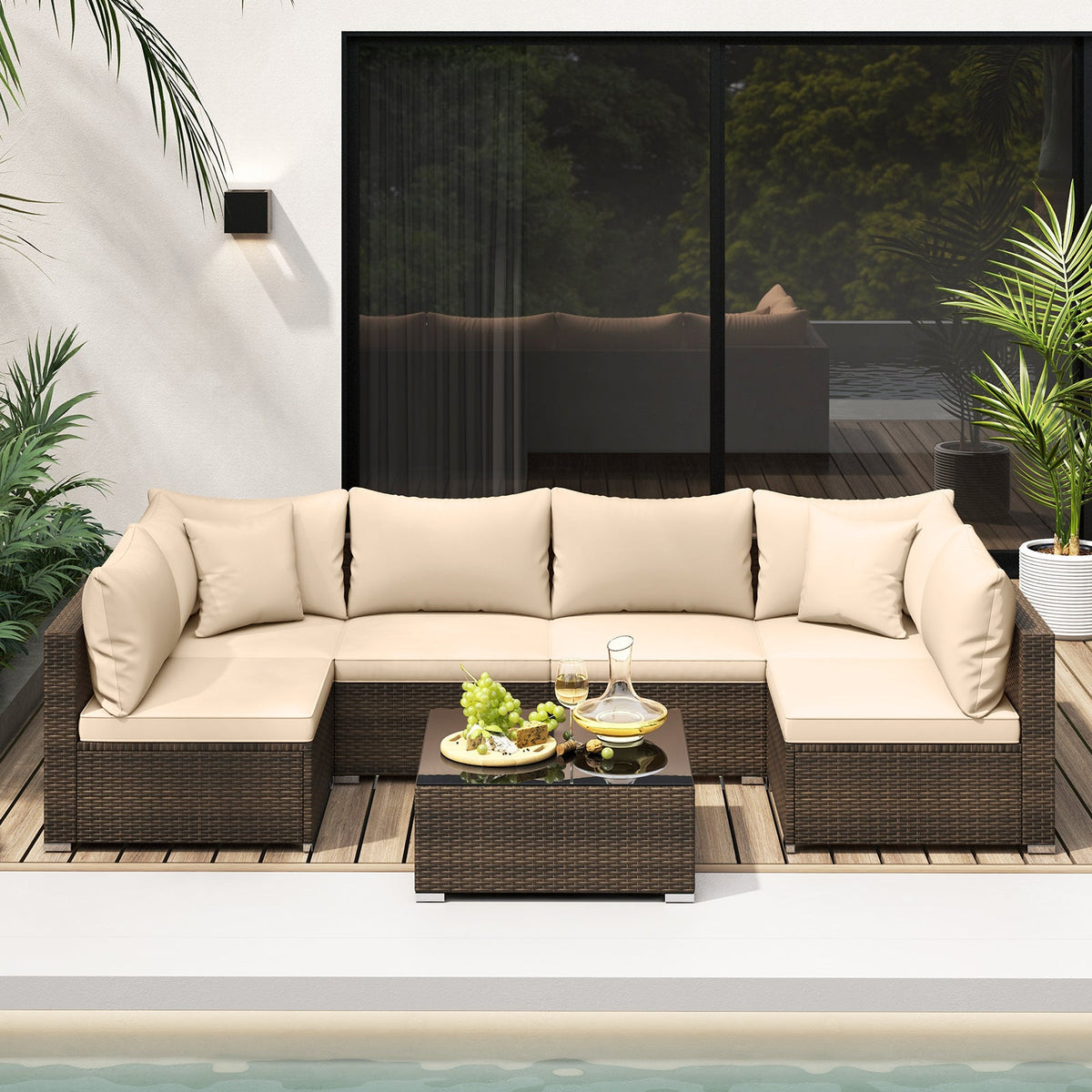 Beige PE rattan sectional seating with cushions and coffee table beside a pool.