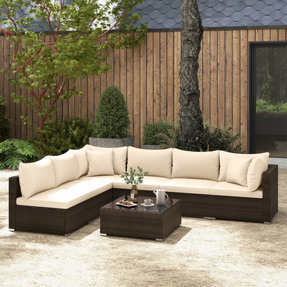 Beige PE rattan sectional seating arranged with a coffee table in an outdoor garden setting.