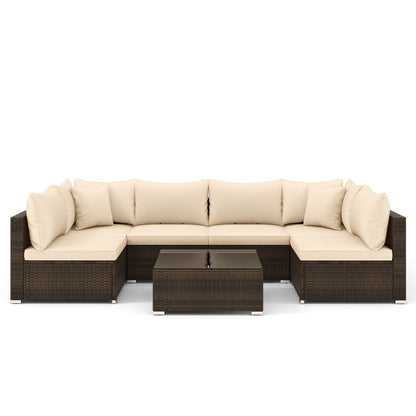 Studio view of the seven-piece beige PE rattan outdoor sectional set with coffee table.