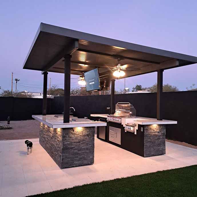 Outdoor kitchen island shown from the side with a built-in grill and mounted TV.