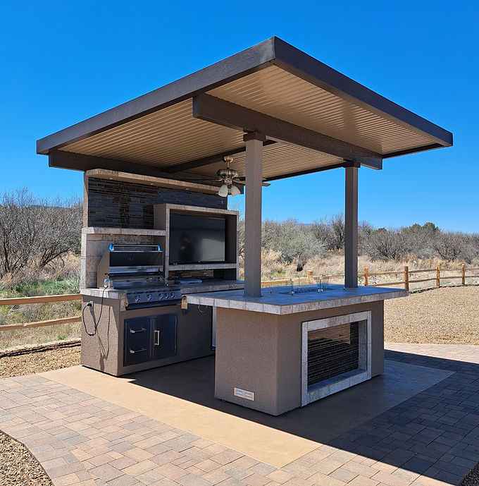 Built-in gas grill on the covered outdoor kitchen island.