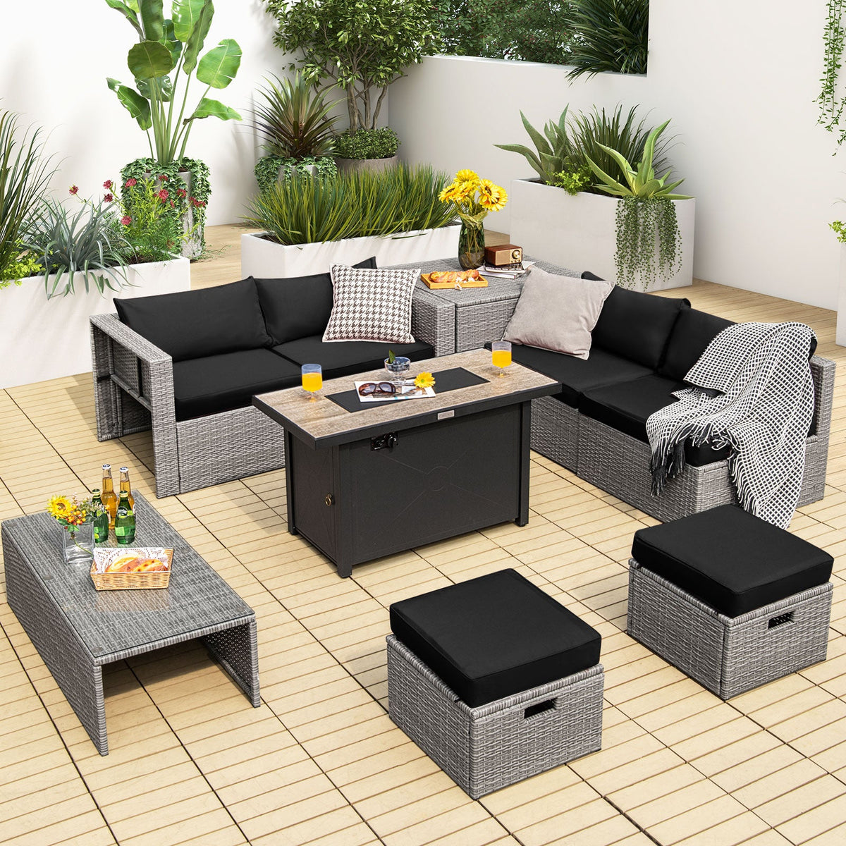Light gray wicker patio set with black cushions arranged on a tile patio.