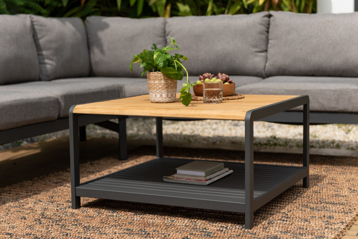 Outdoor sectional sofa and square coffee table arranged on a patio.

