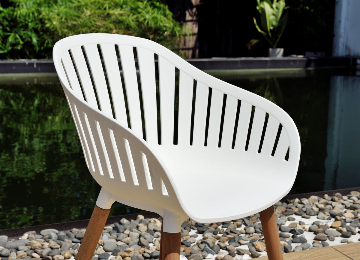 Close-up of a white resin armchair with eucalyptus wood legs.