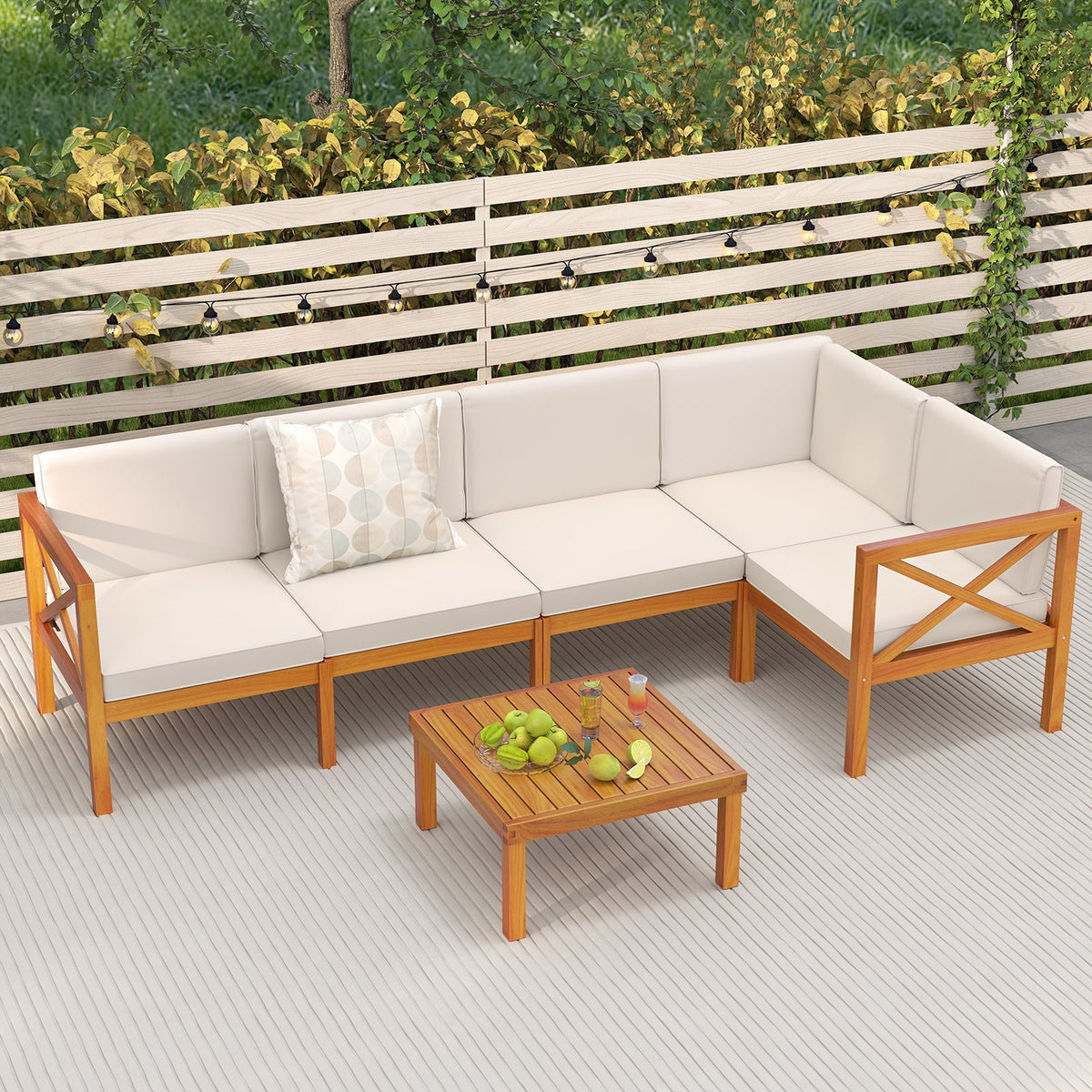 Off-white cushioned acacia wood outdoor sectional with a square coffee table on a deck.

