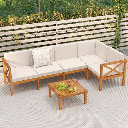 Off-white cushioned acacia wood outdoor sectional with a square coffee table on a deck.
