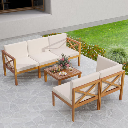 Off-white cushioned acacia wood outdoor sectional with a square coffee table on a stone patio.
