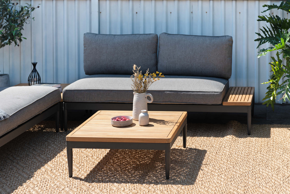 Topaz outdoor seating set with a two-seater sofa and coffee table in a patio arrangement.