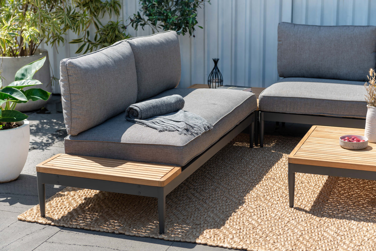 Topaz companion seating piece with gray cushions and a side table surface.