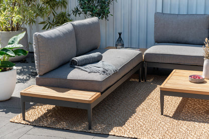 Topaz companion seating piece with gray cushions and a side table surface.