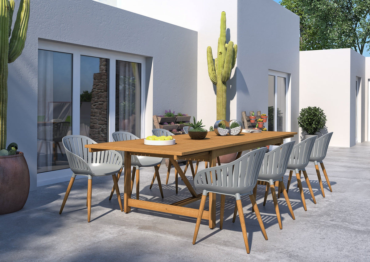 Leyland outdoor dining table with Nassau grey armchairs in a spacious patio setting.