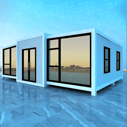 White expandable tiny home exterior on a grassy lawn beneath string lights.