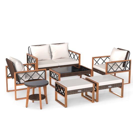 Seven-piece outdoor conversation set with a two-seat sofa, two armchairs, two ottomans, a coffee table, and a side table.