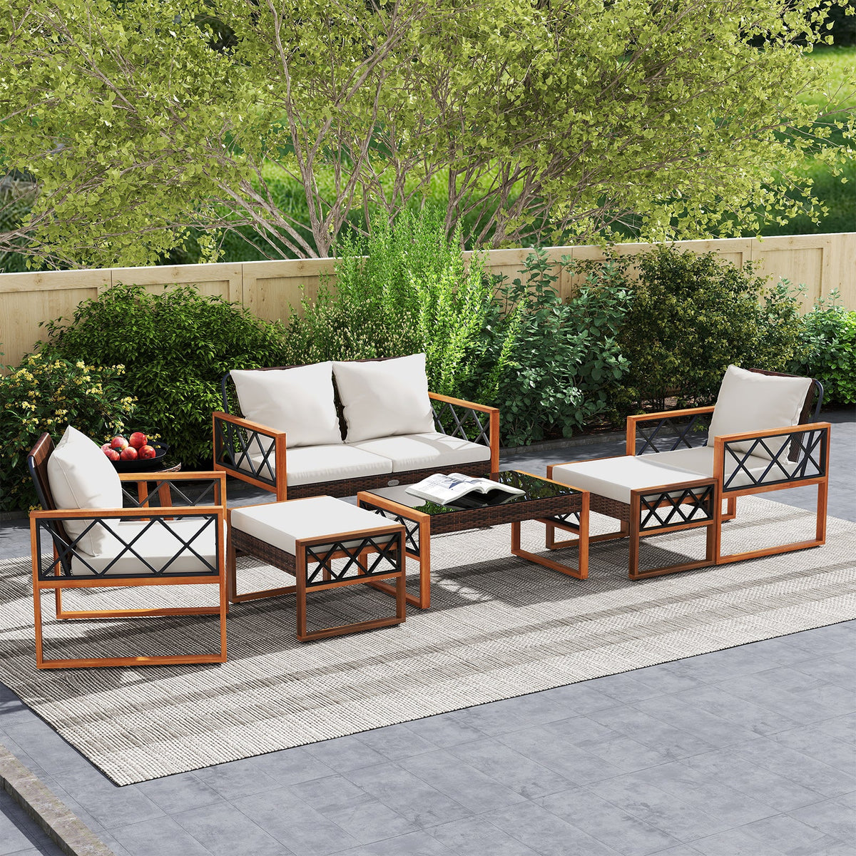 Seven-piece patio conversation set with white cushions arranged on an outdoor rug.