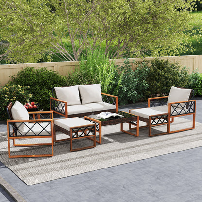 Seven-piece patio conversation set with white cushions arranged on an outdoor rug.